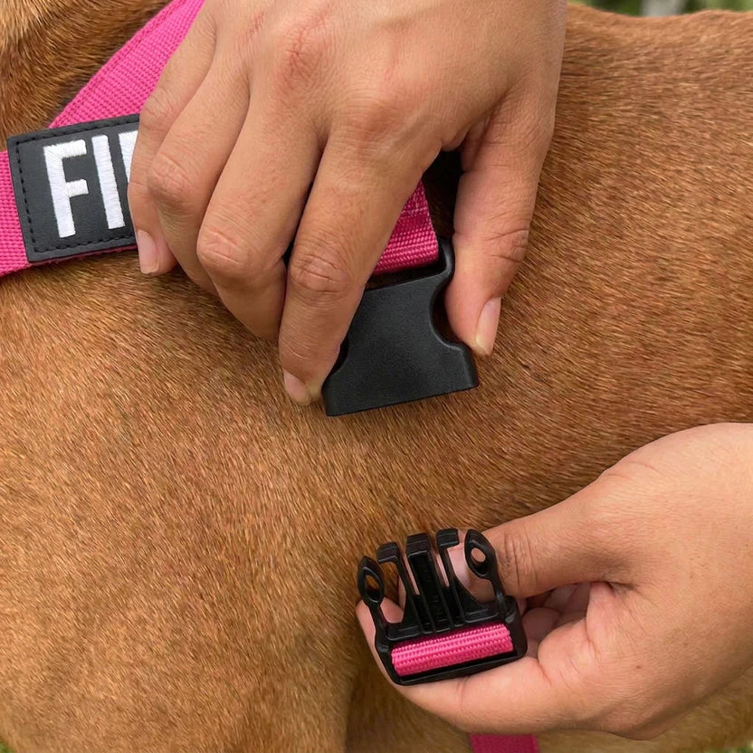 Close-up of hands clipping the one-click ITW buckle